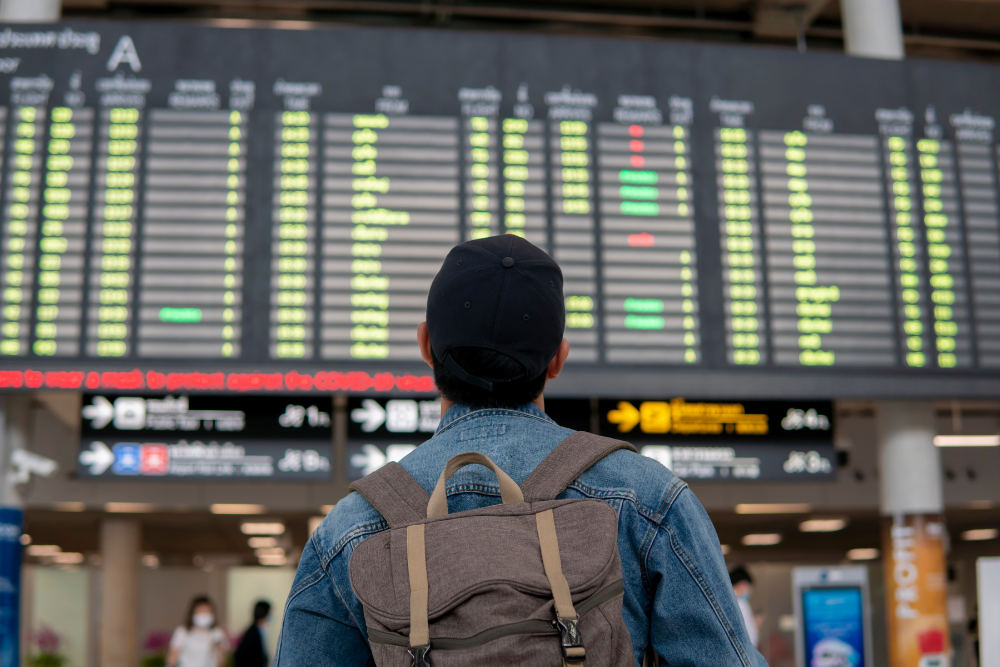 Traveler at an airport looking at the departure board