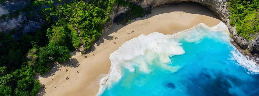 Aerial view of a secluded beach with turquoise waters and surrounding greenery.