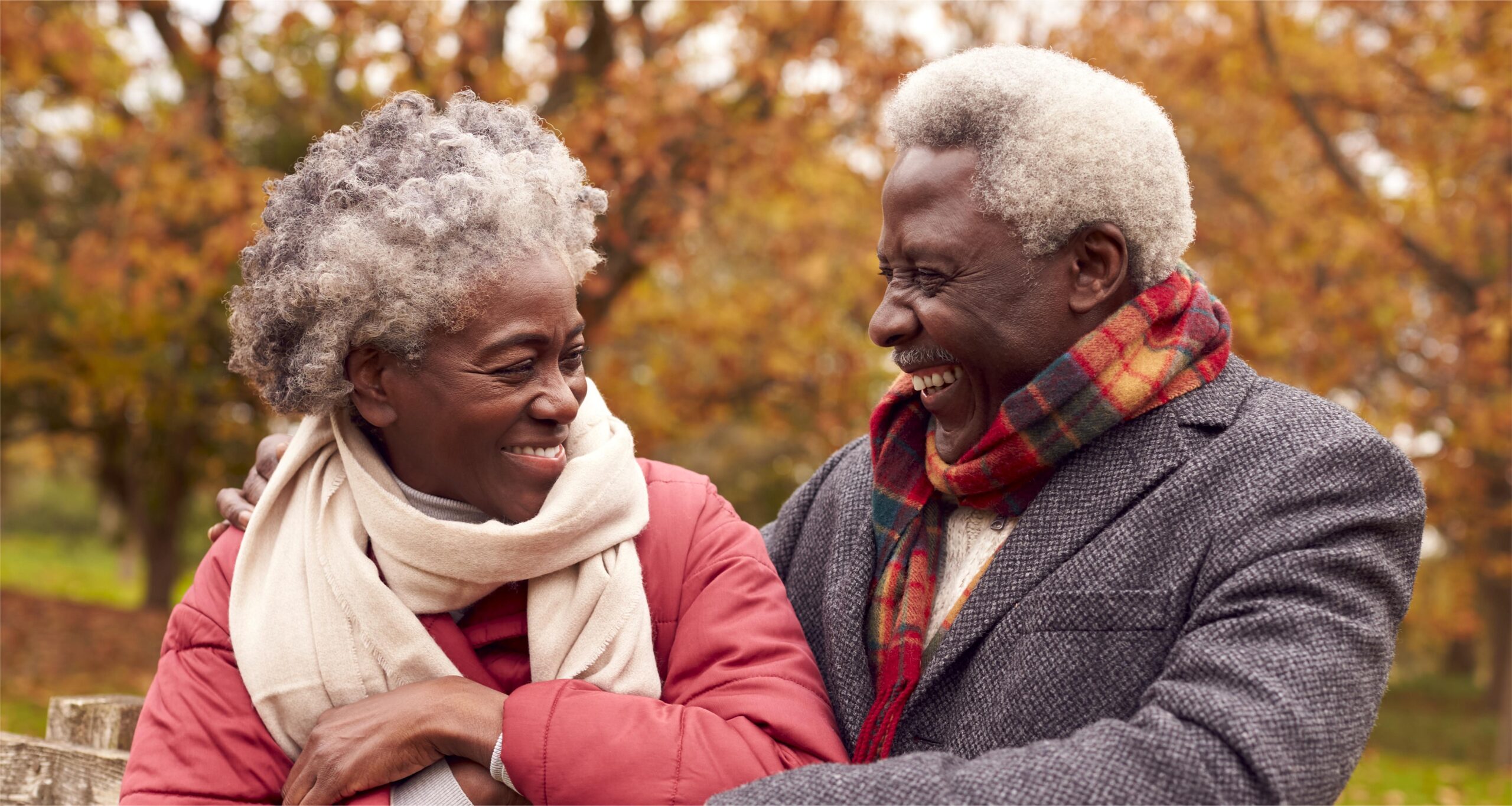 Loving senior couple on a walk through autumn countryside